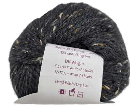Image of a single ball of City Tweed DK Yarn by Knit Picks in the color Obsidian with label on a white background.