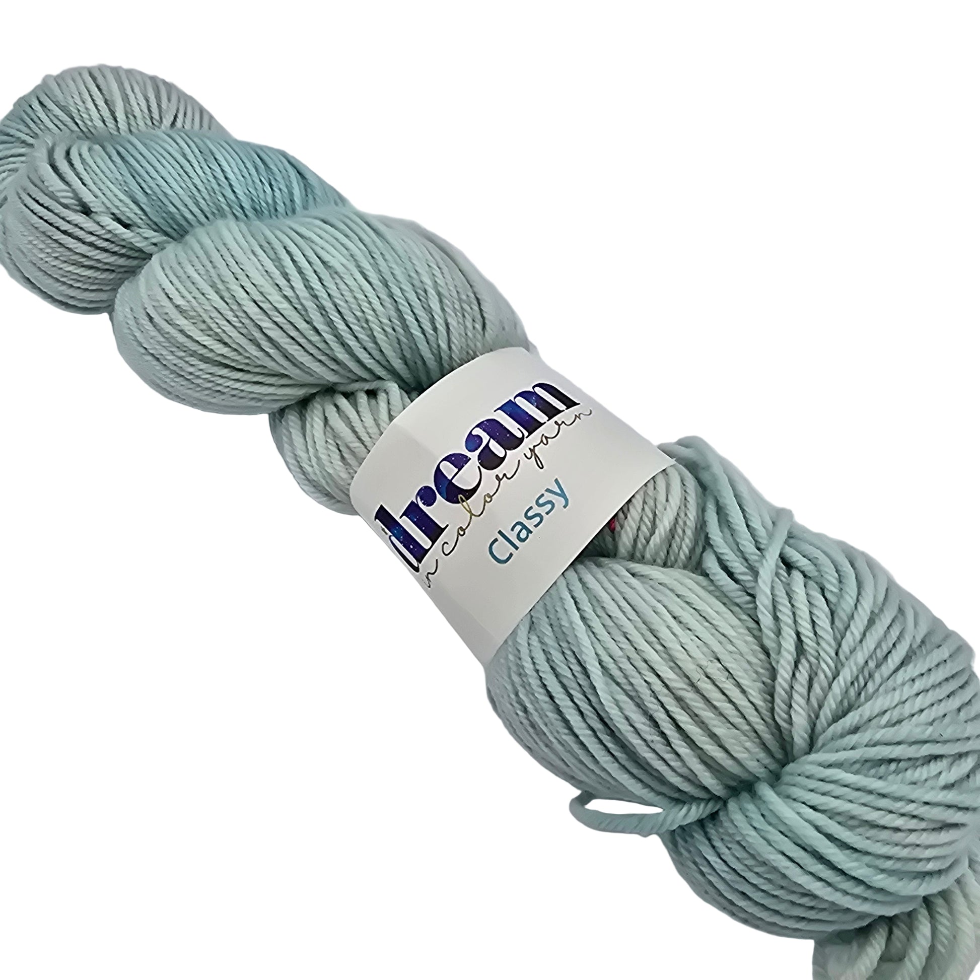 Image of a single skein of Classy by Dream worsted wool merino yarn with label on a white background in a color called spoil the littles which is a pale blue.