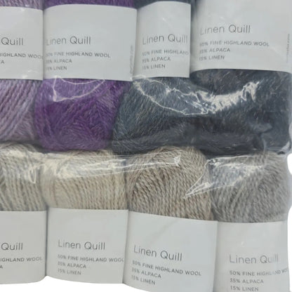 Close-up Image of a set of mini skeins of Purl Soho Linen Quill Yarn Set of 10 Minis in Purple & Neutral colors with labels on a white background.