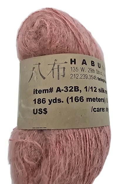 Close-up Image of a single Hank of A-32B Silk Mohair, Kusa Yarn by Habu Textiles in Color 32 with label on a white background.