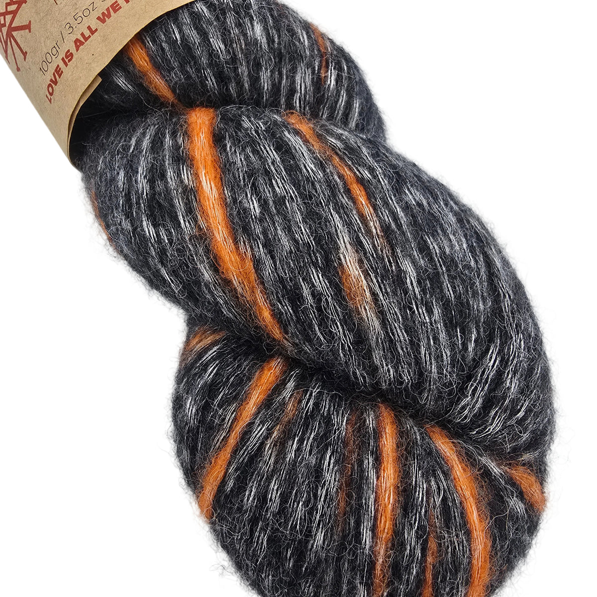 A close-up of a skein of fuzzy yarn with a heathered dark gray and white base and bright orange stripes,
