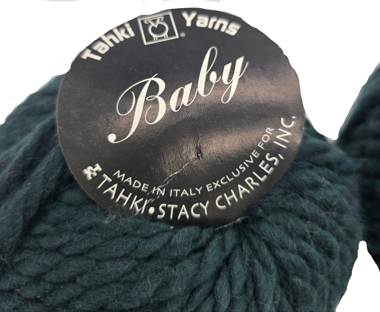 Close-up image of Baby Yarn by Tahki in Color 4 with label on a white background.