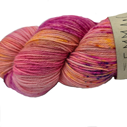 Close-up Image of a single skein of Beautifully Basic yarn by Emma's Yarn  in the color August '23 with partial label on a white background.