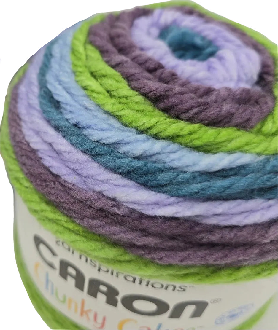 Close-up image of Caron_Chunky_Cakes_Yarn in the color_Galaxy_Macarons with partial label on a white background.