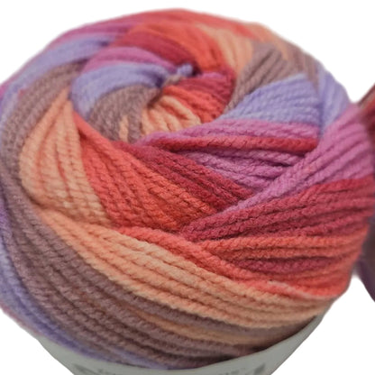 Close-up image of Caron Cinnamon Swirl Cakes yarn in the color Hibiscus on a white background.