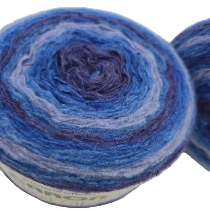 Close-up Image of two cakes of Caron Cloud Cakes Yarn in the color Royal Treatment with labels on a white background.