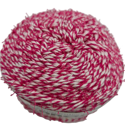 Close-up image fo a single cake of Caron Coconut Cakes -yarn in the color Fuchsia on white background.