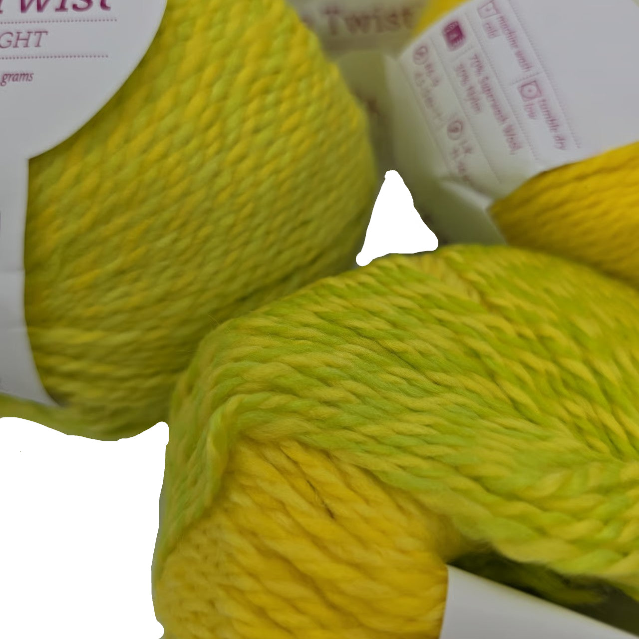 Clsoe-up image of multiple balls of Chroma Twist Worsted Yarn by Knit Picks in the color GoGo Boots with partial label on a white background.