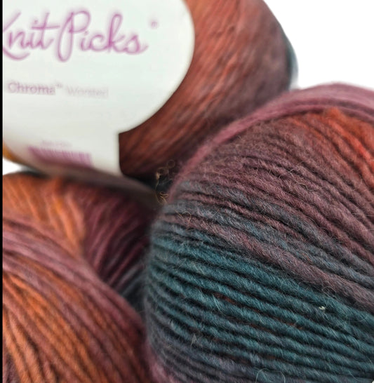 Close-up image of Chroma Worsted Yarn by Knit picks in the color Vermont with partials labels on a white background.
