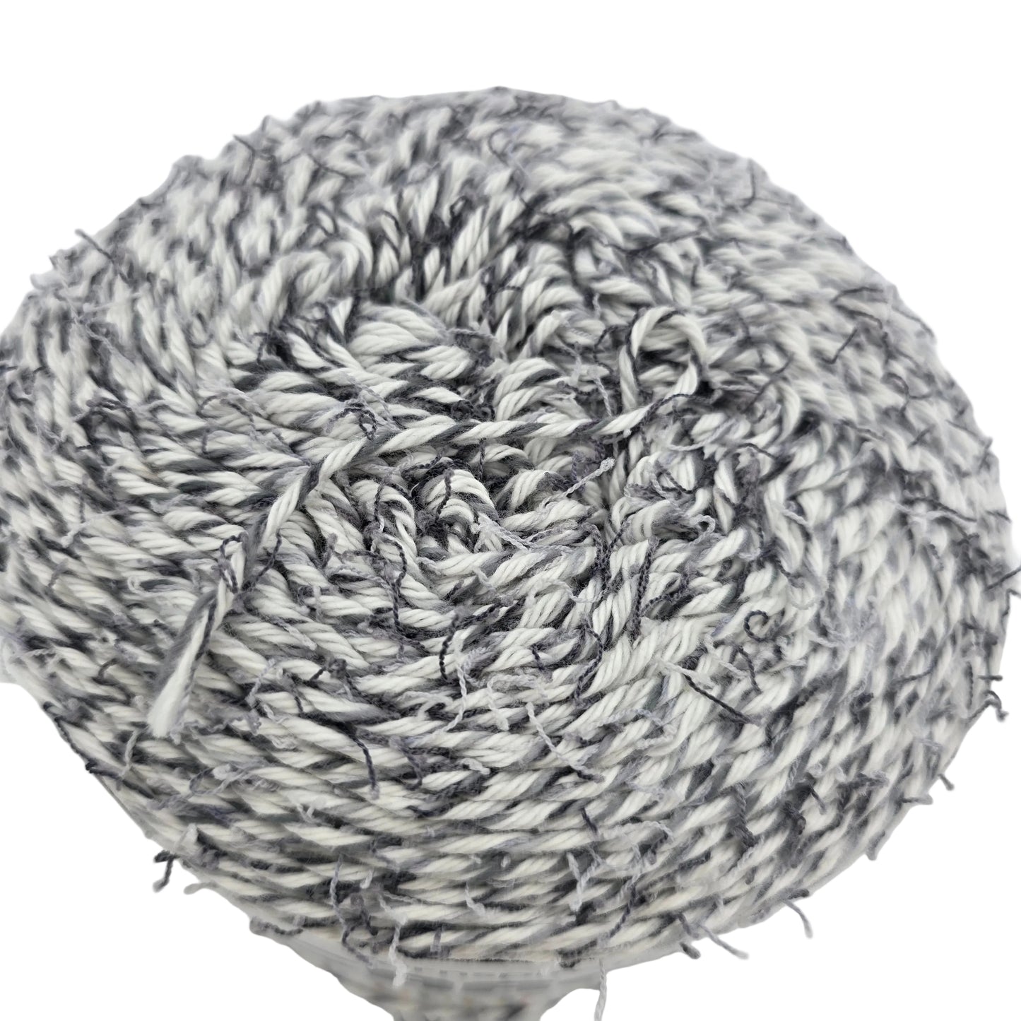Close-up image of a single cake of Coconut_Cakes_by_Caron_Yarn in the color_Cookie_Cream on a white background.