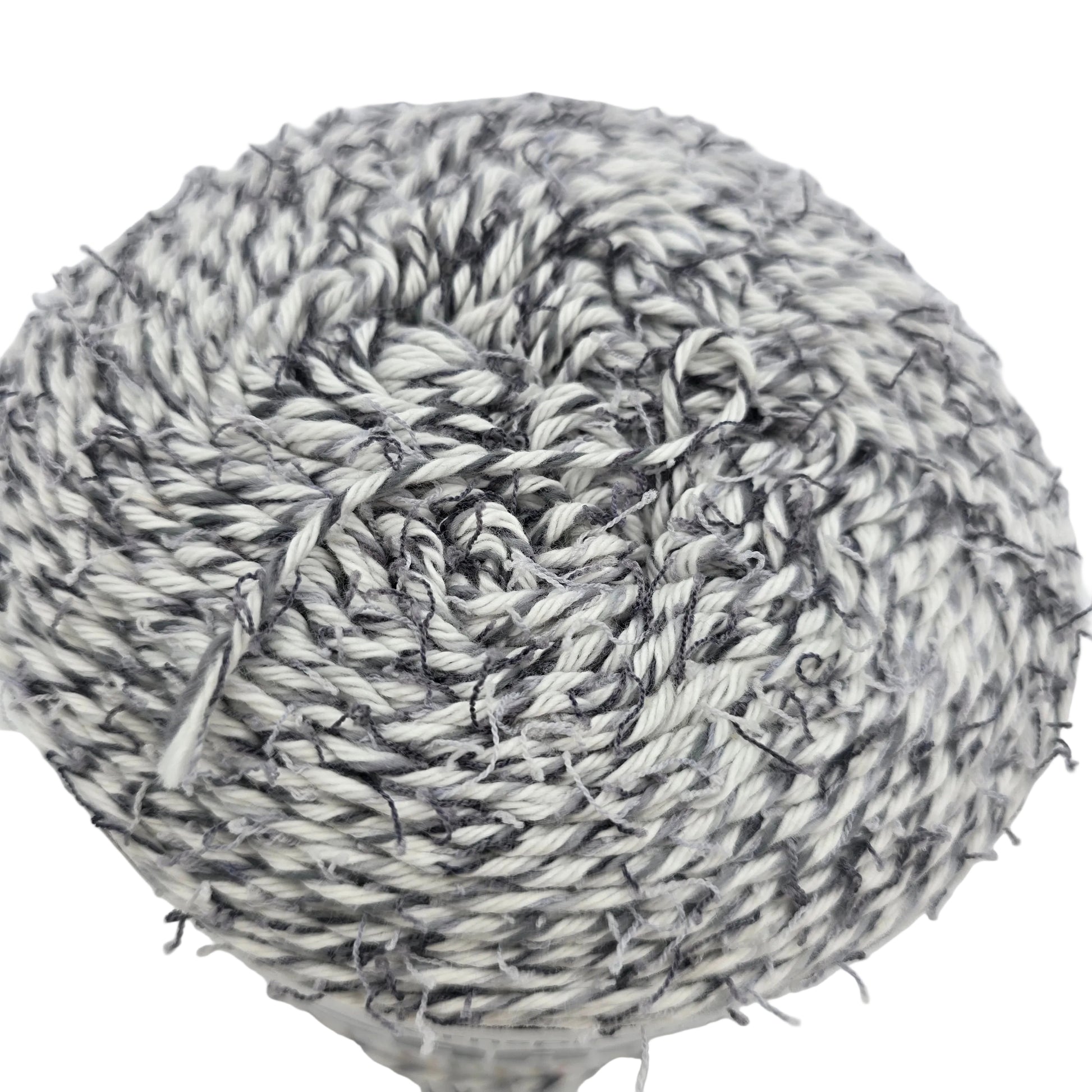 Close-up image of a single cake of Coconut_Cakes_by_Caron_Yarn in the color_Cookie_Cream on a white background.