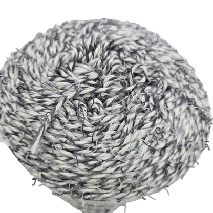 Close-up image of a single cake of Coconut_Cakes_by_Caron_Yarn in the color_Cookie_Cream on a white background.