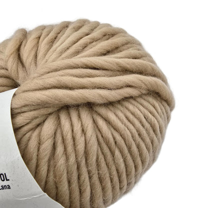 Close-up Image of a single ball of Crazy Sexy Wool Yarn by Wool And The Gang in the color Beige Blonde with partial label visible on a white background.