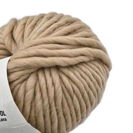 Close-up Image of a single ball of Crazy Sexy Wool Yarn by Wool And The Gang in the color Beige Blonde with partial label visible on a white background.