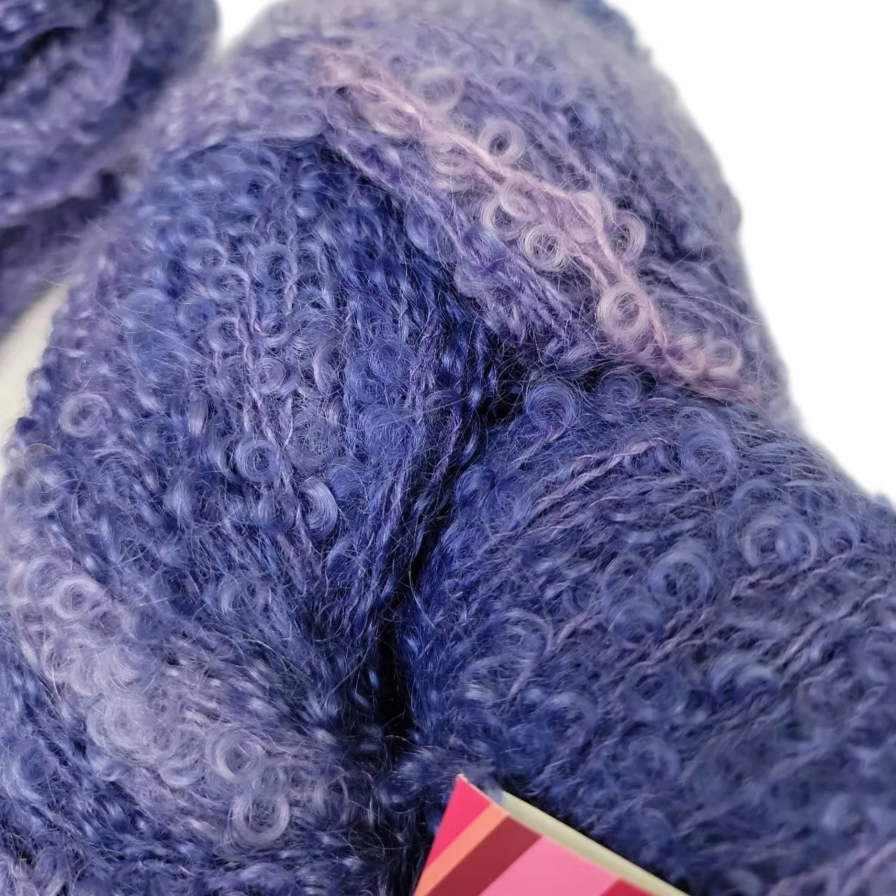 Close-up image of Curly Locks by Fleece Artist Yarn in the color Blueberry  Mist on a white background.
