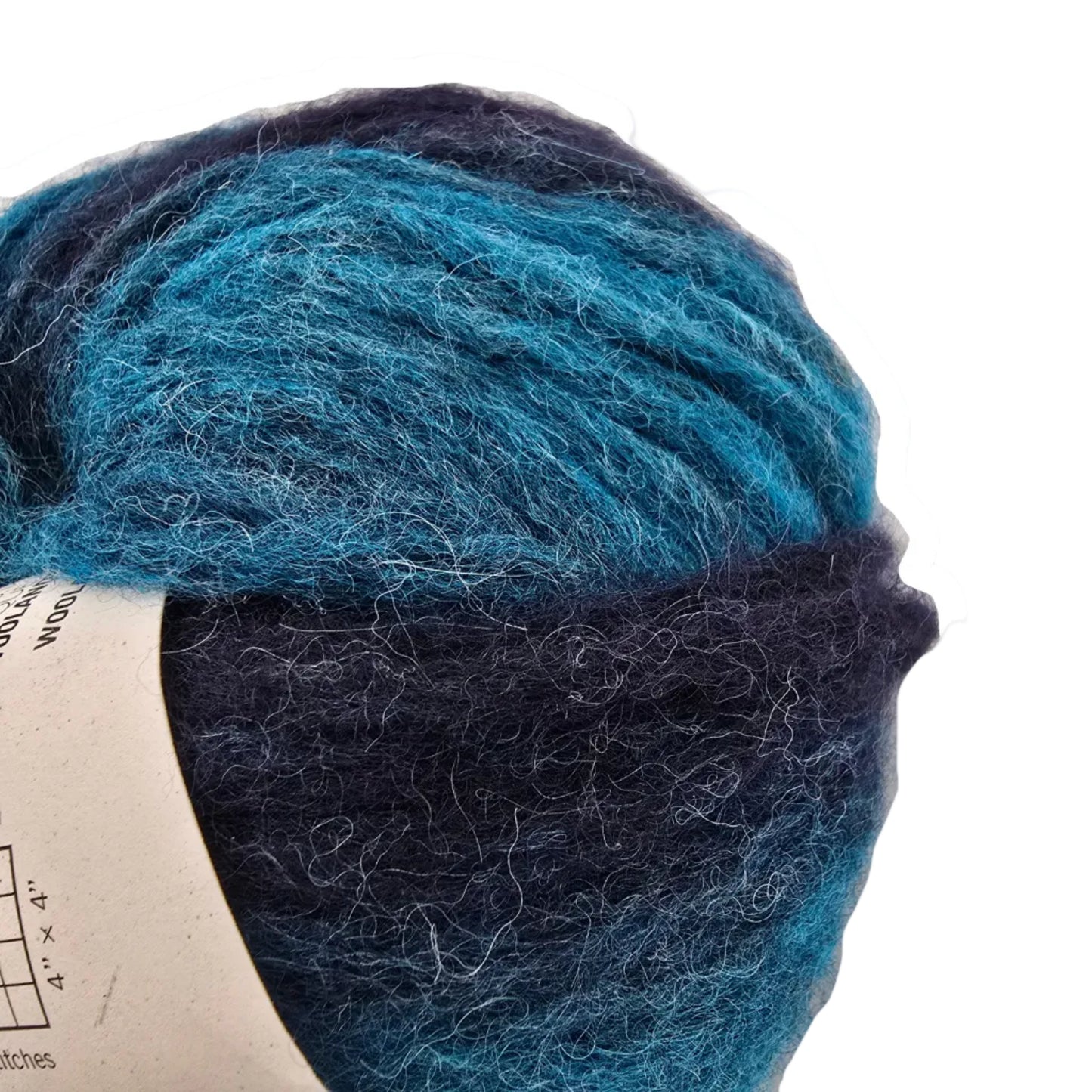 Close-up Image of a single ball of Feeling Good Yarn by Wool And The Gang in the color Northern Lights Green Stripe with label on a white background.