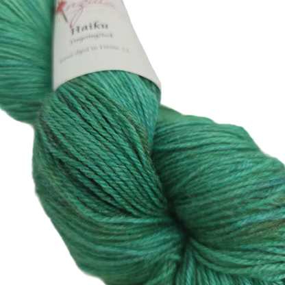 Close-up image of Haiku by Anzula in the color Peacock with partial label on a white background.