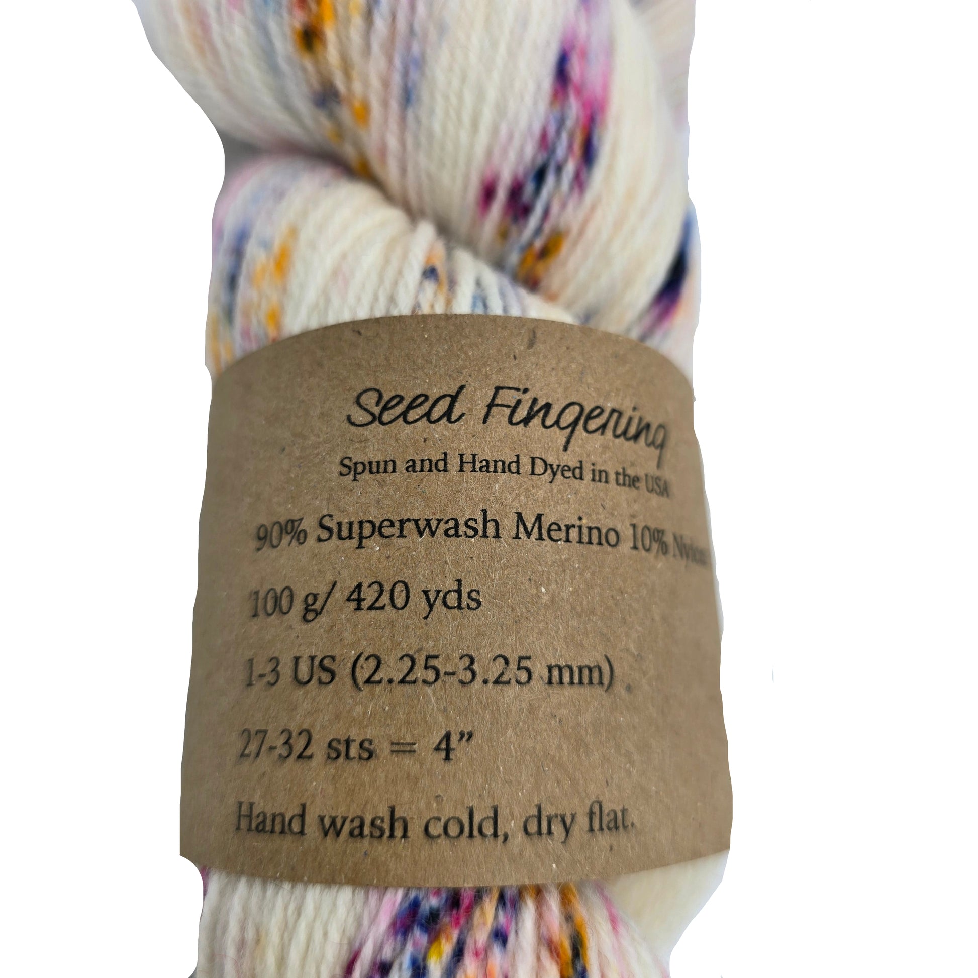 Close-up image of Seed Fingering Yarn by Heidi & Lana  in the color Sunkissed with label on a white background.