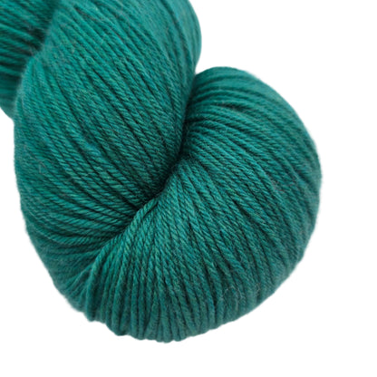 Close-up Image of a single skein of Heritage 150 Sock Yarn by Cascade Yarns in the color Ultramarine Green with label on a white background.