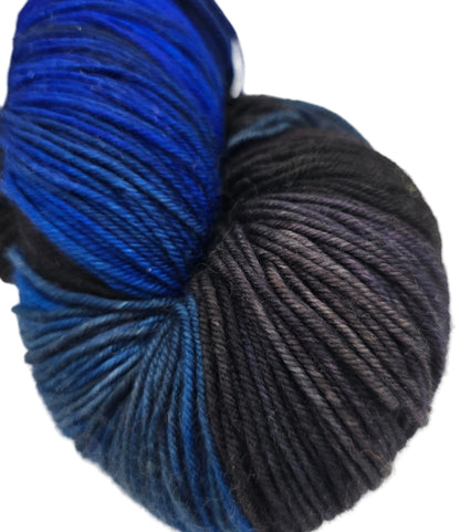 Close-up image of Kiki Yarn by Fleece Artist in the color Twilight on a white background.