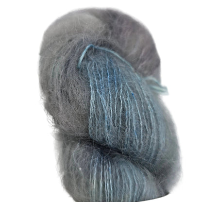 Close-up image of a single skein of Marvelous Mohair yarn by Emma's Yarn in the color Chasing Waterfalls on a white background.