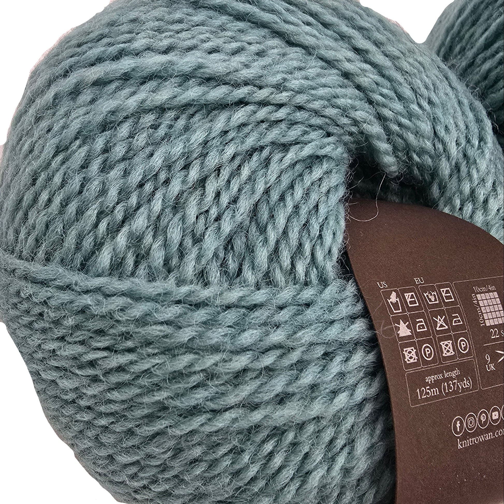 Close-up image of a single ball of Norwegian_Wool_by_Rowan in color 022 Mountain with label on a white background.