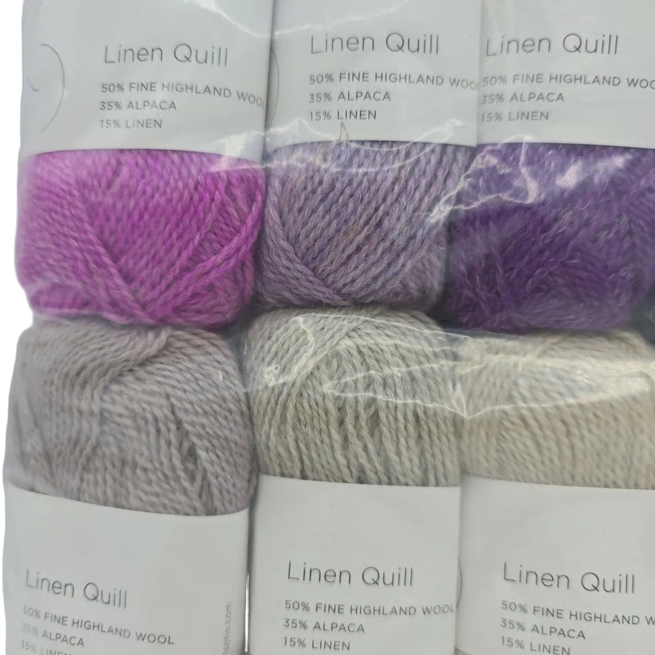 Close-up Image of a set of mini skeins of Purl Soho Linen Quill Yarn Set of 10 Minis in Purple & Neutral colors with labels on a white background.