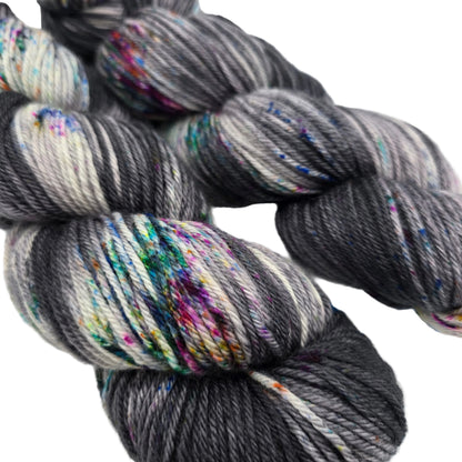 Close-up image of two skeins of Springvale DK yarn by Three Irish Girls Yarn Inc. in the color Sunday Funnies on a white background.
