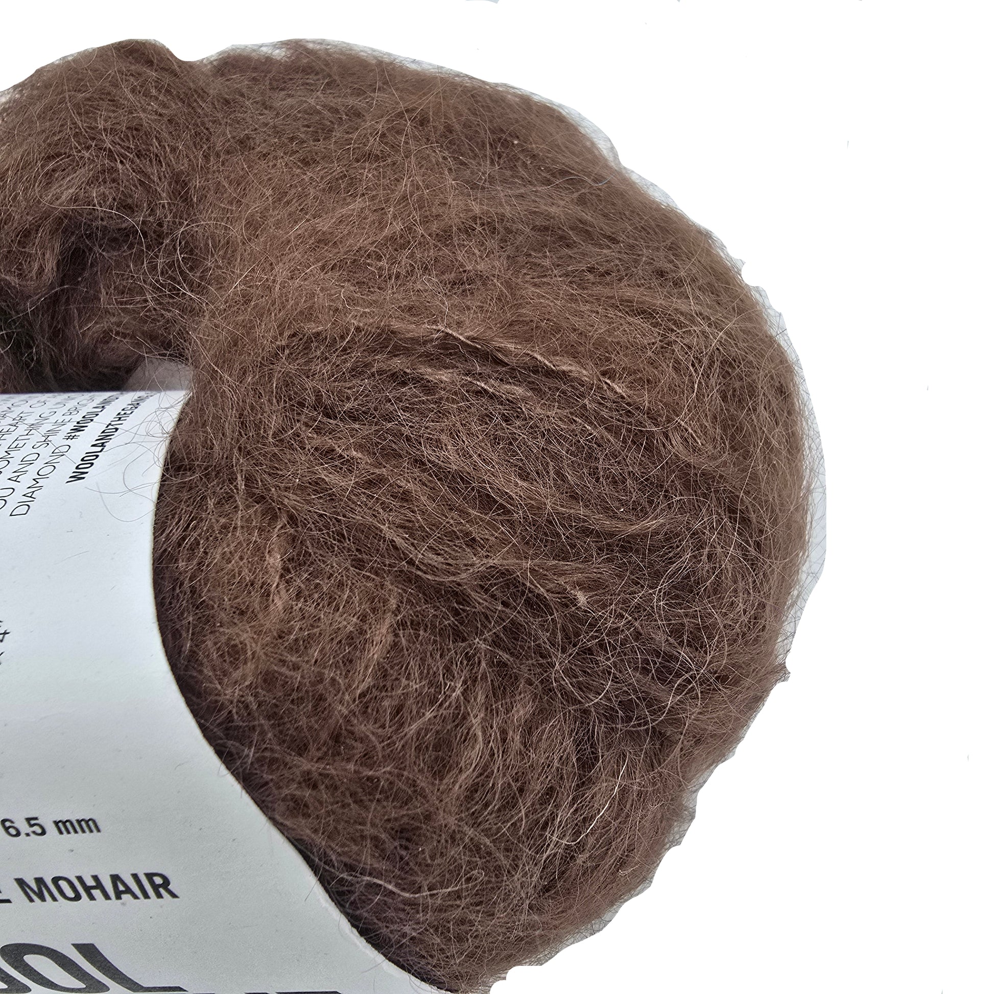 Close-up Image of a single ball of Take Care Mohair Yarn by Wool And The Gang the color Chocolate Brown with label on a white background.