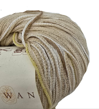 A close-up of a ball of Tetra_Cotton_by_Rowan in color_3 shades of beige, cream, and light brown, with a paper label on a white background.