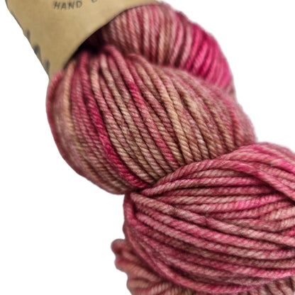 Close-up image of Tosh_Vintage_Yarn_by_Madelinetosh_in the color _Fragrant with partial label on a white background.