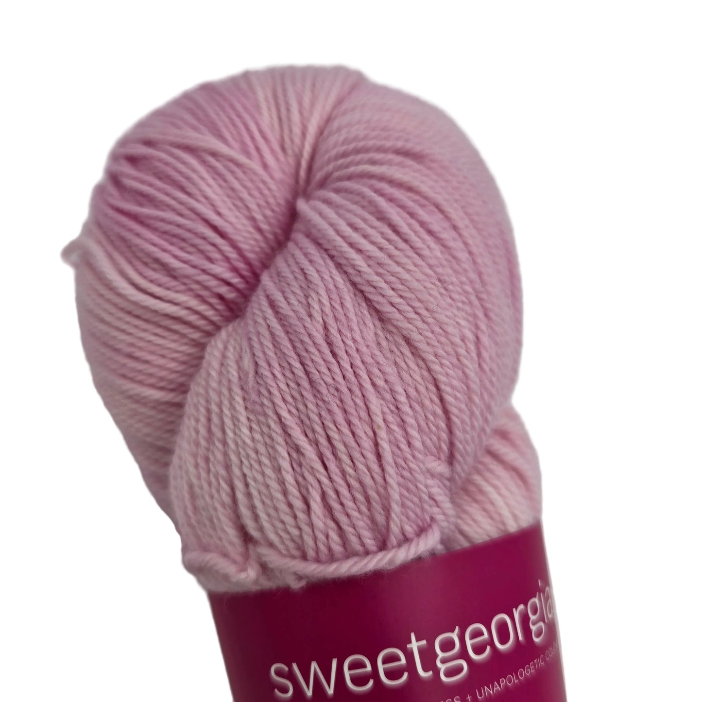 Close-up image of Tough Love Sock by SweetGeorgia Yarns  in the color Candy Floss with partial label on a white background.