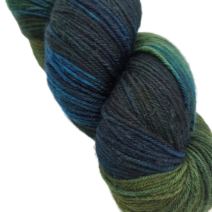 Close-up Image of a single hank of Yowza Light Worsted Yarn by Miss Babs in the color Blue Dasher on a white background.