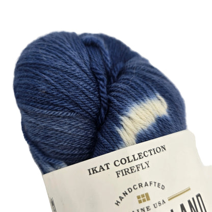 Close-up image of Ikat Collection Firefly Yarn by Swans Island in the color Firefly Prussian Blue IFF203 with a partial label on a white background.