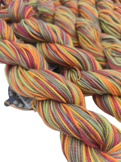 Close-up image of Lily Multi  Yarn by Noro - Color 119 Fruit Salad with partial label on a white background.