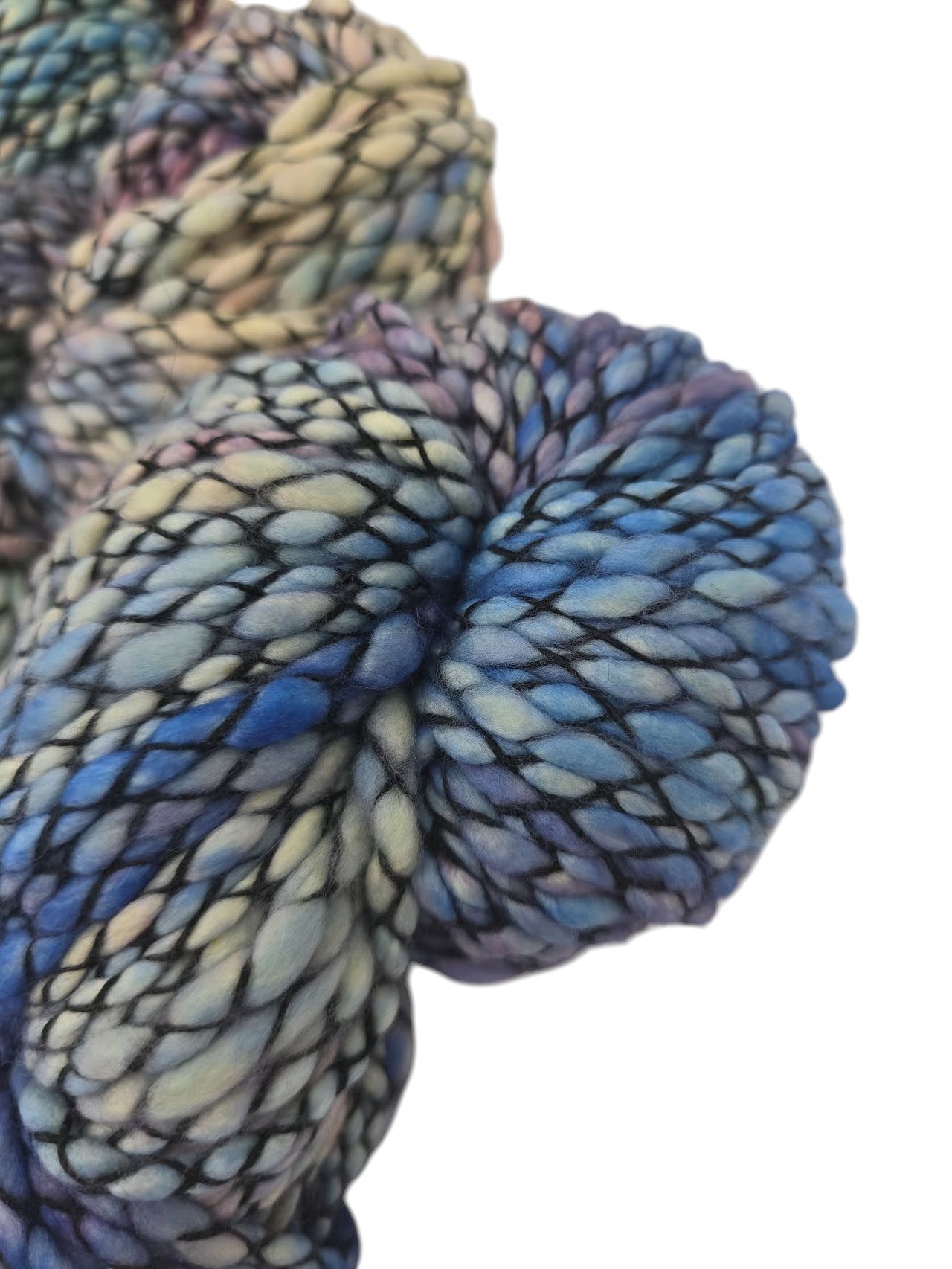 Close-up image of texture of Multicolored Skeins of Caracol by Malabrigo Bulky Merino Wool yarn on a white background