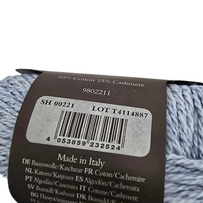 Close-up of backside of the label on a ball of Cotton Cashmere yarn by rowan in the color morning sky on a white background.