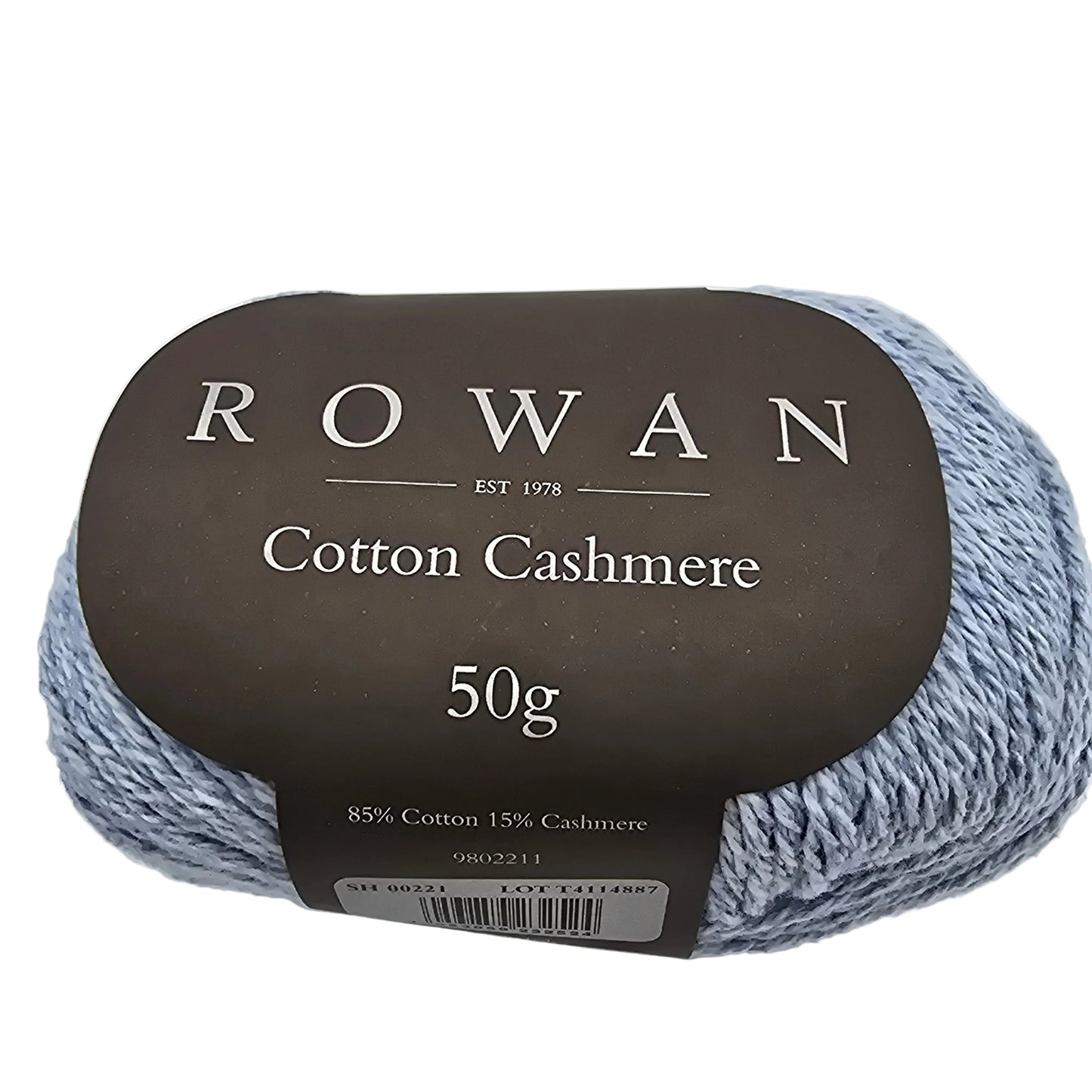 Close-up of the label on a ball of Cotton Cashmere yarn by Rowan in color Morning sky on a white background.