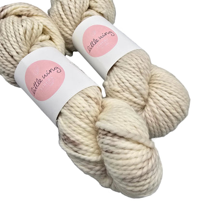 Two skeins of Cloud Bulky yarn by Little Wing fibers with labels on a white background.