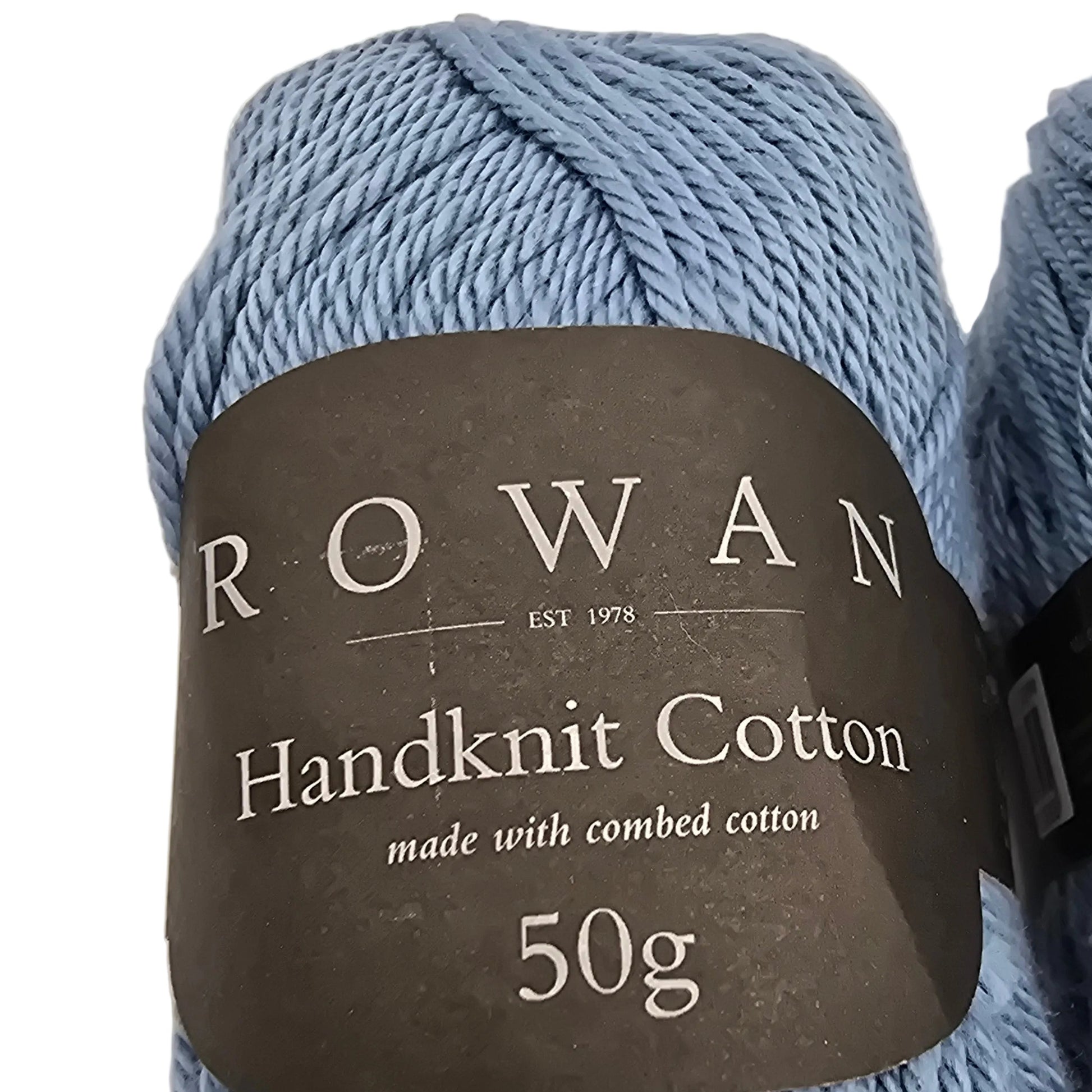 Close-up Image of a single skein of Handknit Cotton Yarn by Rowan in color 239 Ice Water with labels in a white background.