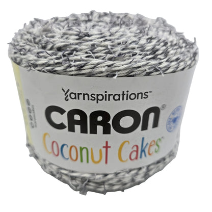 Image of single cake of Coconut Cakes by Caron Yarn in the color Cookie Cream with label on white background.