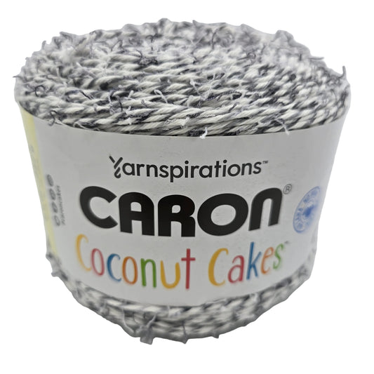 Image of single cake of Coconut Cakes by Caron Yarn in the color Cookie Cream with label on white background.