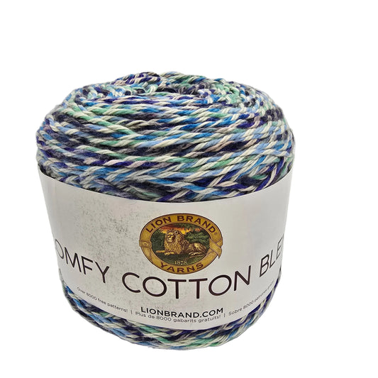 Image of single cake of Comfy_Cotton_Blend_Yarn by_Lion_Brand_in the color Ocean_Breeze_-709 with label on a white background.