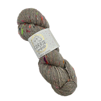 Image of a single skein of Corrie_Confetti_Yarn by_La_Bien_Aimee in the color_Greybow_2_from Fall_Winter_2021_ with label on a white background.