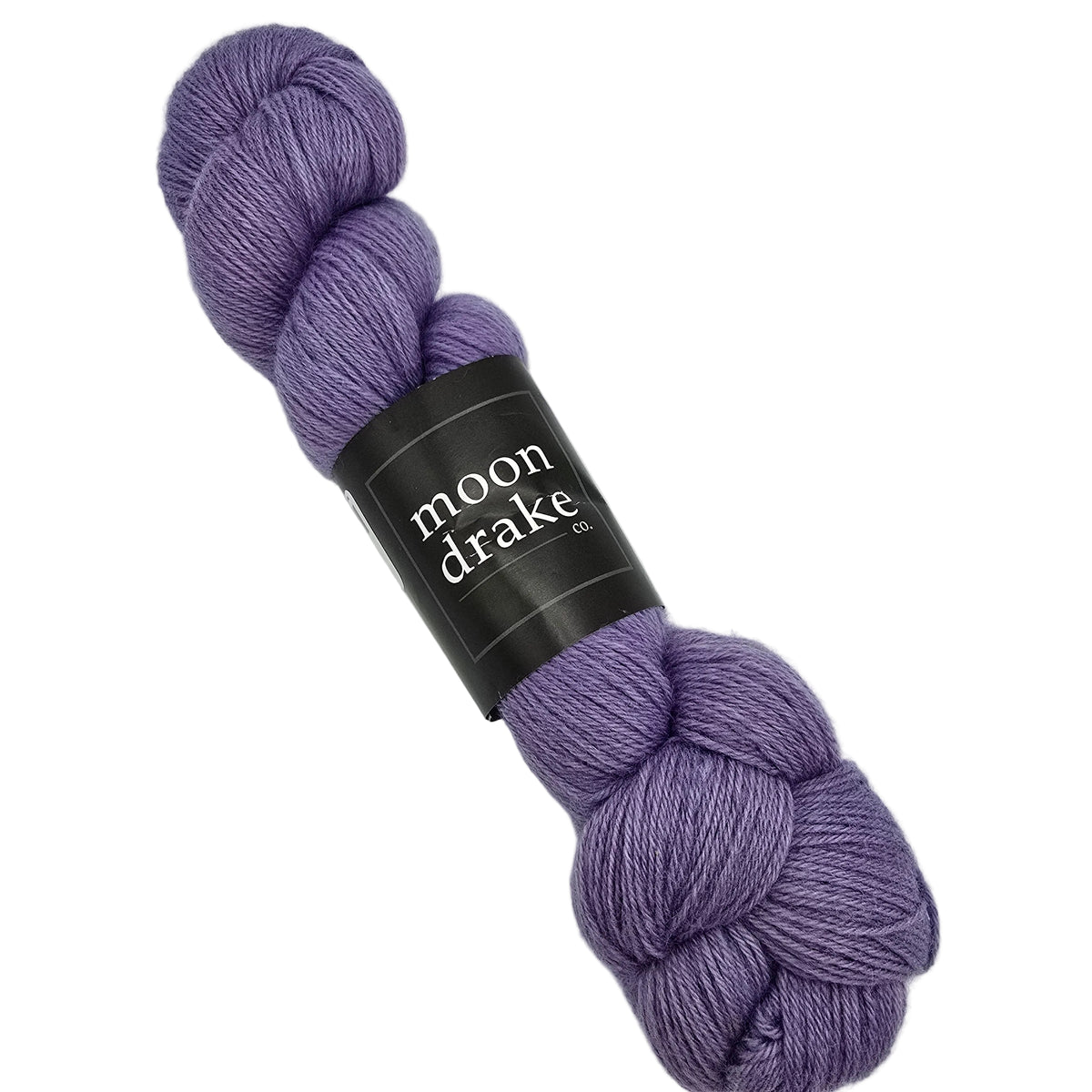 A skein of Corridale Fingering Yarn by Moon Drake Co. in Liliac a dusty lavender-purple color, wrapped with a black paper label, on a solid white background.