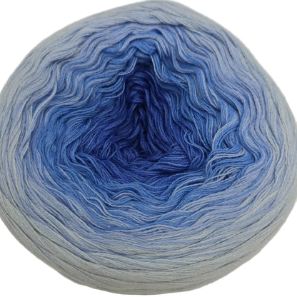 Image of a single cake of Cotton_Kings_Twirls_Yarn by_Hobbii_-in color 04_Blue_Sandstone on a white background.