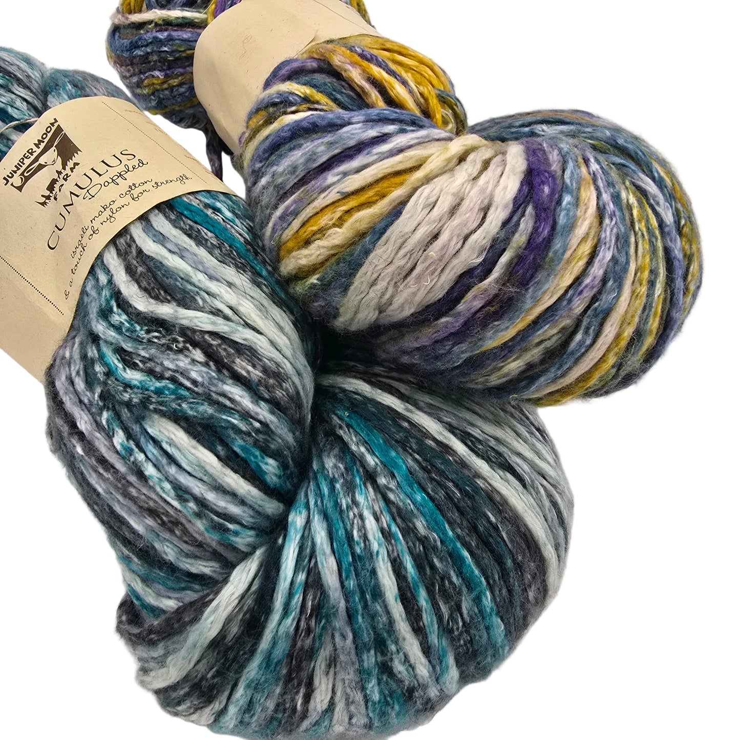 Image of two skeins of Cumulus Dappled  Yarn by Juniper Moon Farm in variegated blues and purples with labels on a white background.