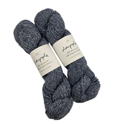 Image of two skeins of dapple yarn by Brooklyn Tween in the color Cosmos with labels on a white background.