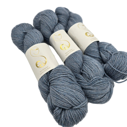 Image of three hanks of Eriu Elements DK yarn in the color Wisp with labels on a white background.