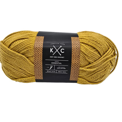 Image of single skein of Essential Cotton Yarn by K+C in the color Golden Coast a yellow yarn with label on a white background.